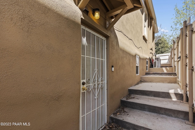 entrance to property with stucco siding