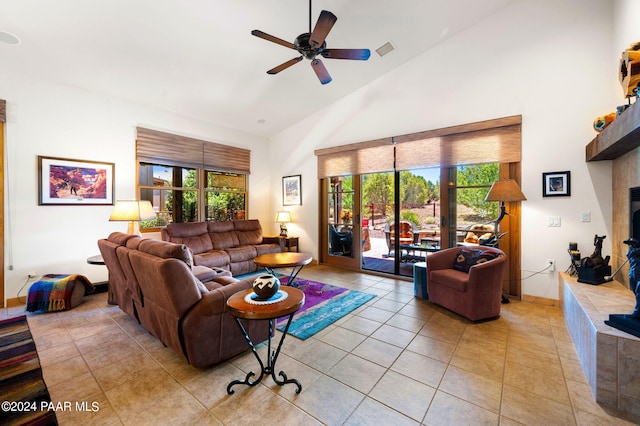 living room featuring ceiling fan, light tile patterned floors, and a wealth of natural light