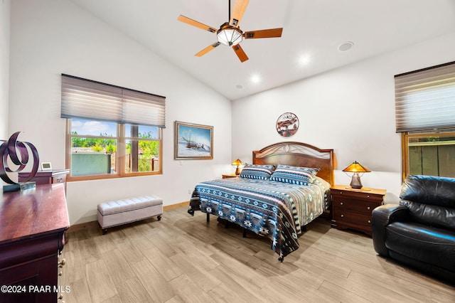 bedroom with ceiling fan, light hardwood / wood-style floors, and vaulted ceiling