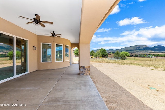 view of patio with a mountain view and ceiling fan