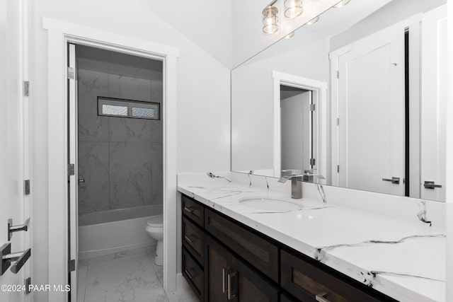 full bathroom with vanity, tiled shower / bath combo, and toilet