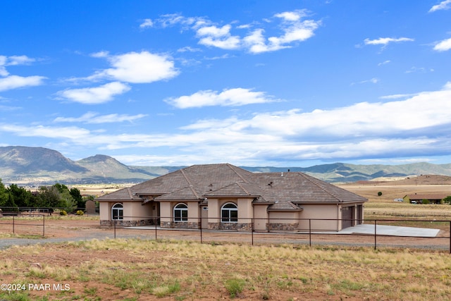 view of front facade with a mountain view and a garage