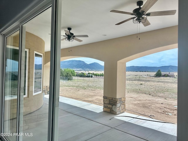 entryway featuring a mountain view and ceiling fan