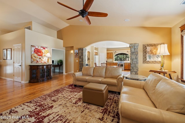 115 E Rosser St, Prescott, AZ 86301 - living area with arched walkways, a ceiling fan, light wood finished floors, ornate columns, and vaulted ceiling