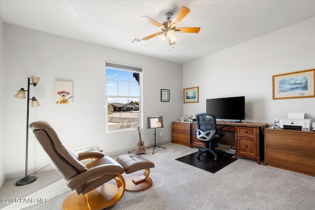 home office with visible vents, light carpet, and a ceiling fan