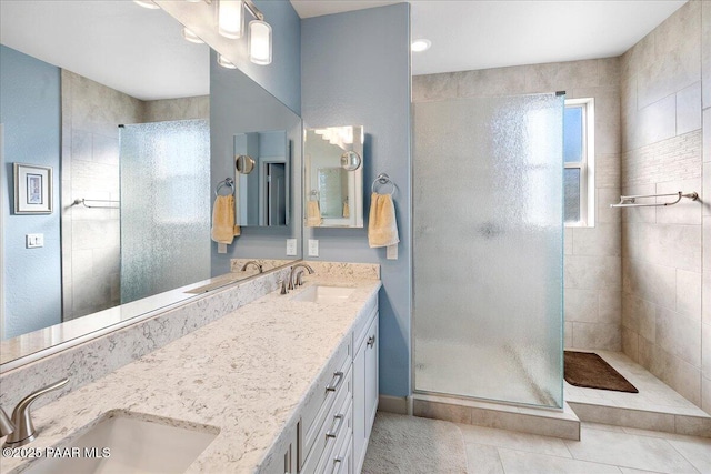 bathroom featuring a tile shower and a sink