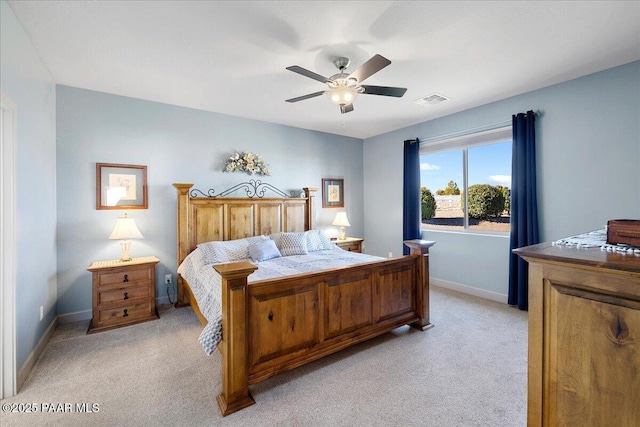bedroom with visible vents, baseboards, light colored carpet, and ceiling fan