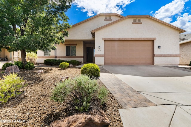 4276 N Pembroke St, Prescott Valley, AZ 86314 - view of front of house featuring an attached garage, stucco siding, and driveway