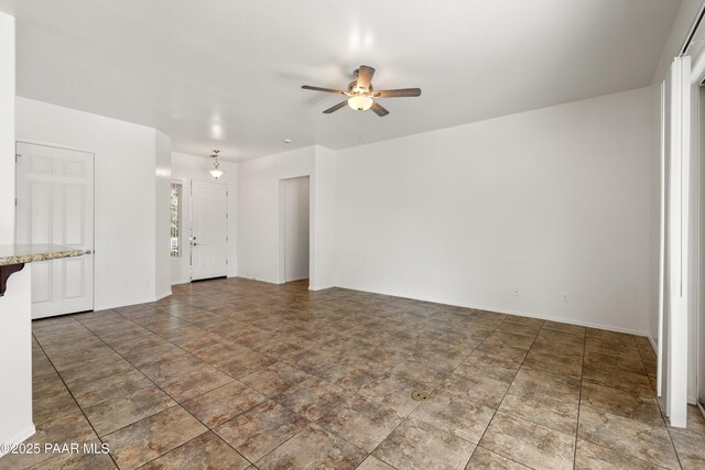 4276 N Pembroke St, Prescott Valley, AZ 86314 - unfurnished living room featuring a ceiling fan and baseboards