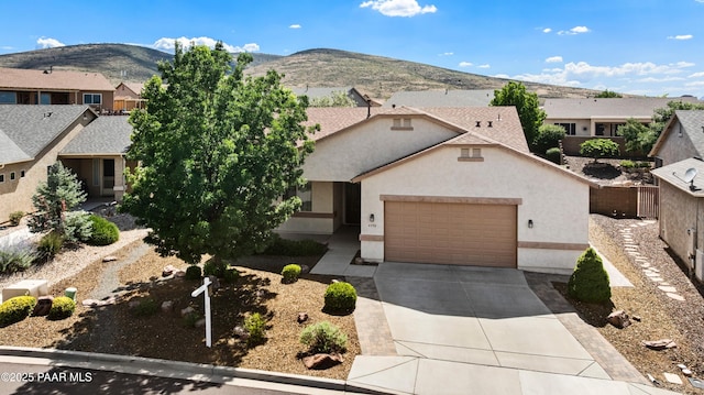 4276 N Pembroke St, Prescott Valley, AZ 86314 - view of front of home with concrete driveway, a garage, a residential view, a mountain view, and stucco siding