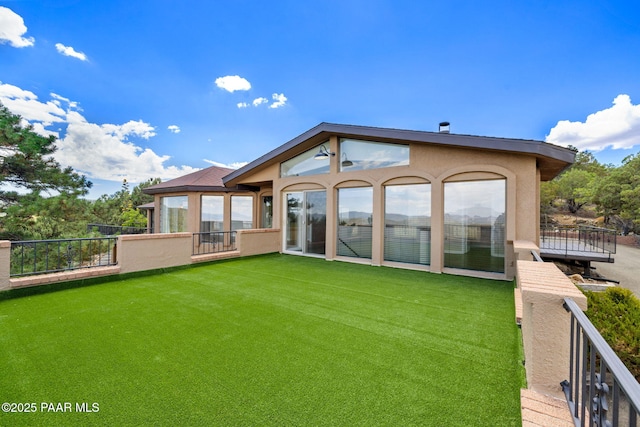 5712 W Sunrise Dr, Prescott, AZ 86305 - back of property with stucco siding, a balcony, and a lawn