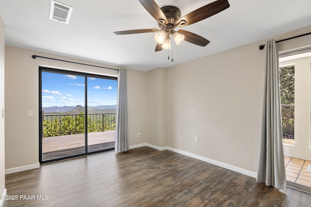 5712 W Sunrise Dr, Prescott, AZ 86305 - spare room with dark wood finished floors, a mountain view, and ceiling fan