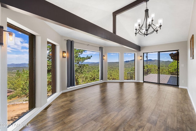 5712 W Sunrise Dr, Prescott, AZ 86305 - empty room featuring a chandelier, a mountain view, wood finished floors, and high vaulted ceiling
