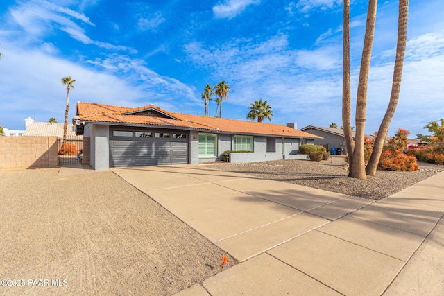 502 E Le Marche Ave, Phoenix, AZ 85022 - ranch-style home featuring a tile roof, a gate, fence, concrete driveway, and an attached garage