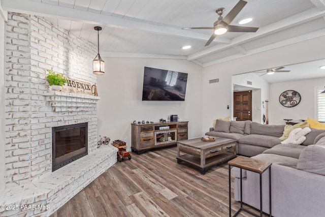 502 E Le Marche Ave, Phoenix, AZ 85022 - living room featuring visible vents, a ceiling fan, lofted ceiling with beams, wood finished floors, and a fireplace