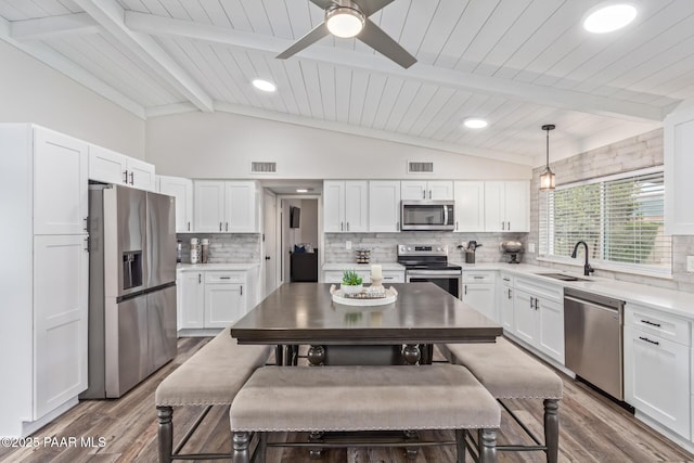 502 E Le Marche Ave, Phoenix, AZ 85022 - kitchen with visible vents, appliances with stainless steel finishes, lofted ceiling with beams, and a sink