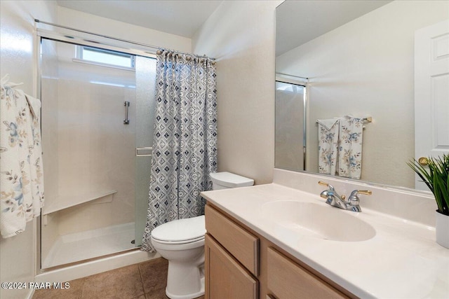 bathroom with tile patterned flooring, a shower with curtain, vanity, and toilet