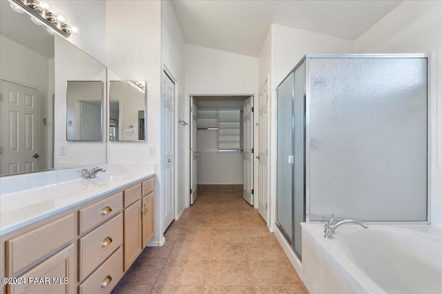 bathroom featuring tile patterned flooring, vanity, lofted ceiling, and plus walk in shower