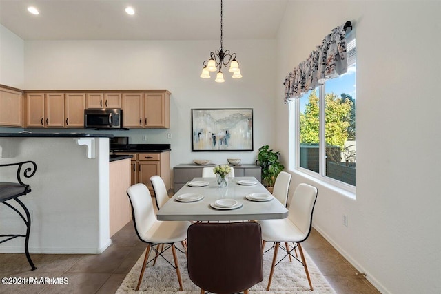 dining room featuring tile patterned floors and an inviting chandelier