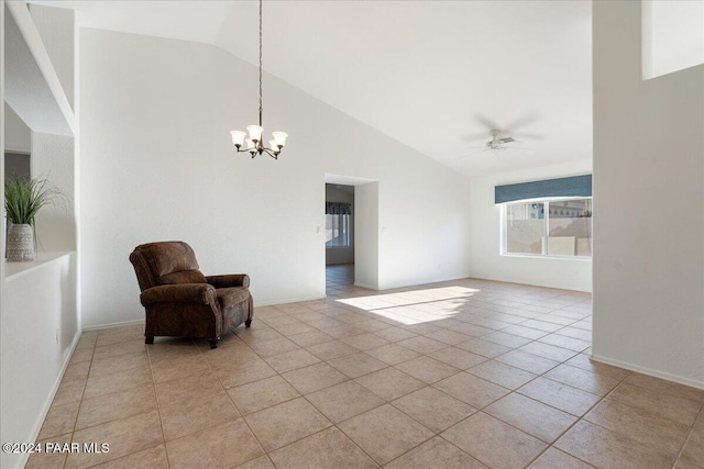 sitting room with light tile patterned floors, ceiling fan with notable chandelier, and high vaulted ceiling