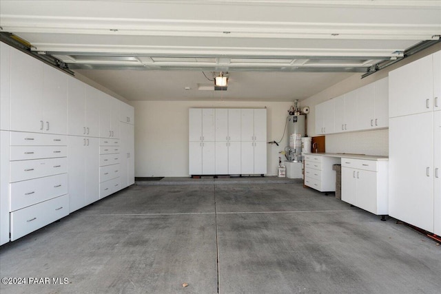 garage with a garage door opener and gas water heater