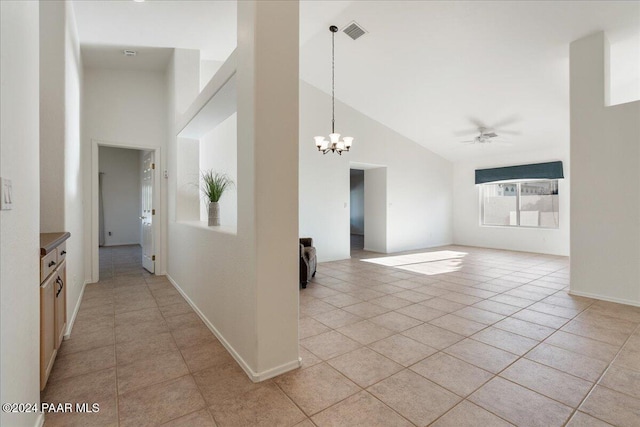 interior space featuring high vaulted ceiling, light tile patterned flooring, and an inviting chandelier