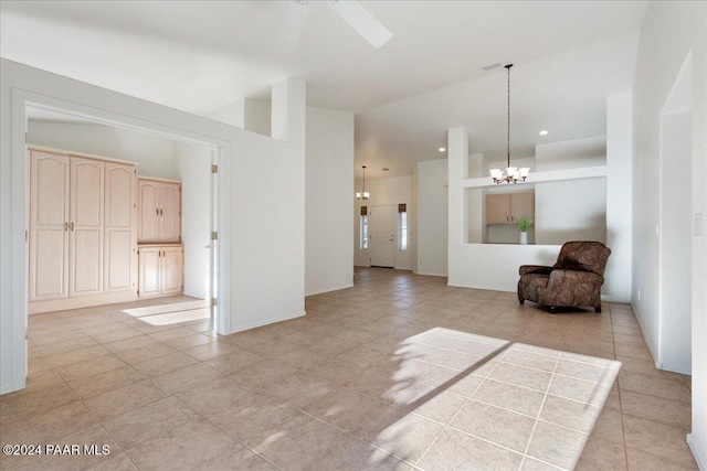 interior space featuring light tile patterned floors and ceiling fan with notable chandelier