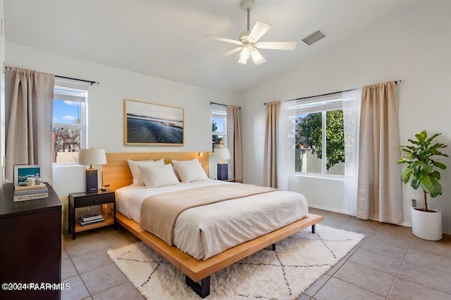 tiled bedroom featuring ceiling fan and lofted ceiling