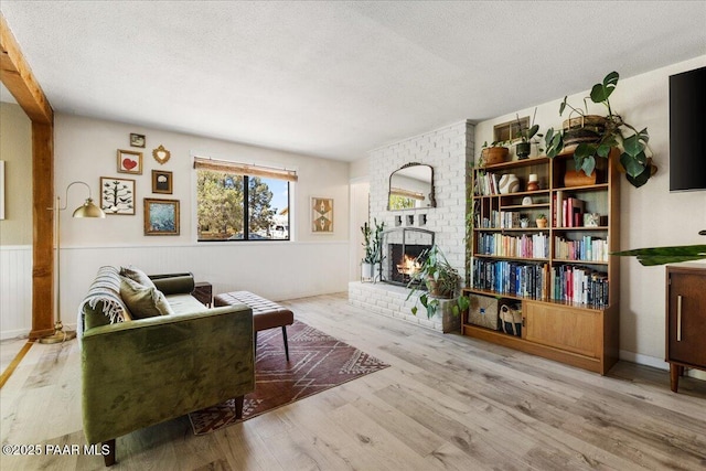714 Mingus Ave, Prescott, AZ 86301 - living area featuring a fireplace, wood finished floors, and a textured ceiling