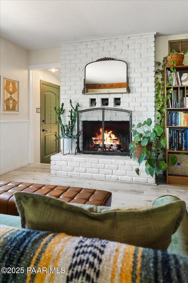 714 Mingus Ave, Prescott, AZ 86301 - living area with a fireplace, wood finished floors, and wainscoting
