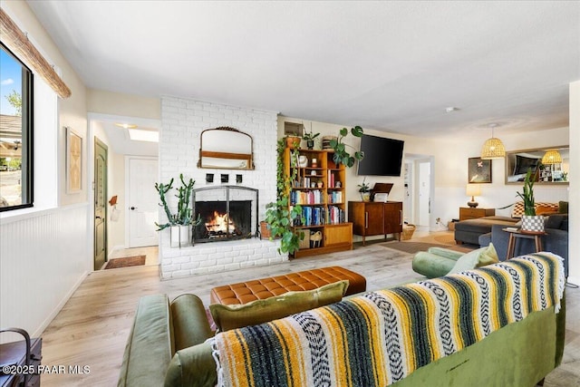 714 Mingus Ave, Prescott, AZ 86301 - living room with wood finished floors, a brick fireplace, and a wainscoted wall