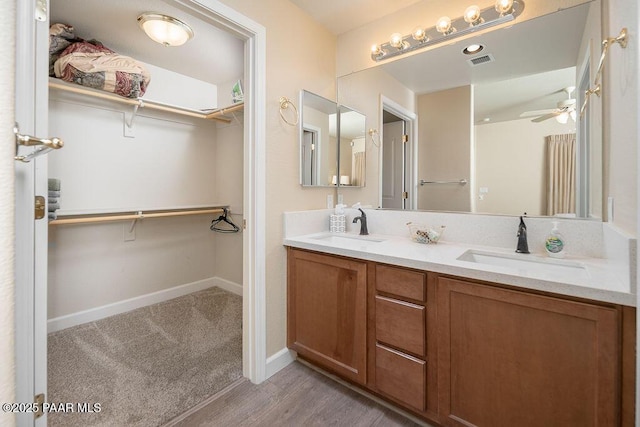 bathroom featuring vanity, hardwood / wood-style flooring, and ceiling fan