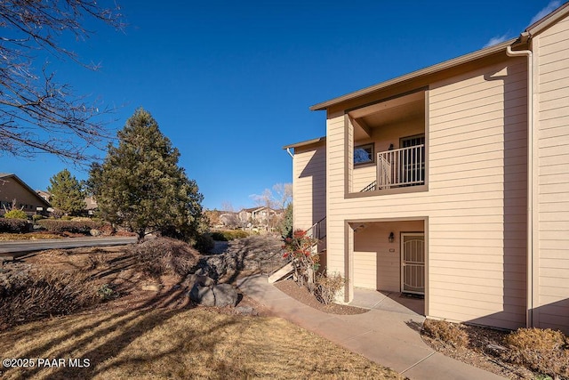 view of side of home featuring a balcony