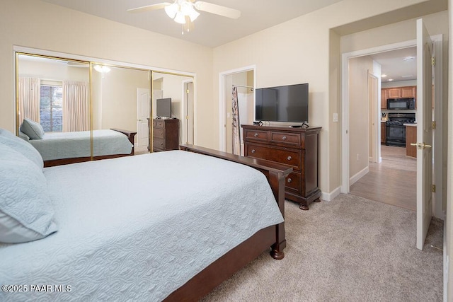 carpeted bedroom featuring a closet and ceiling fan