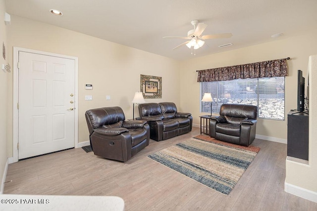 living room featuring light hardwood / wood-style floors and ceiling fan