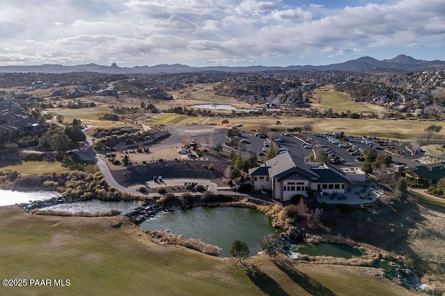 drone / aerial view featuring a water and mountain view