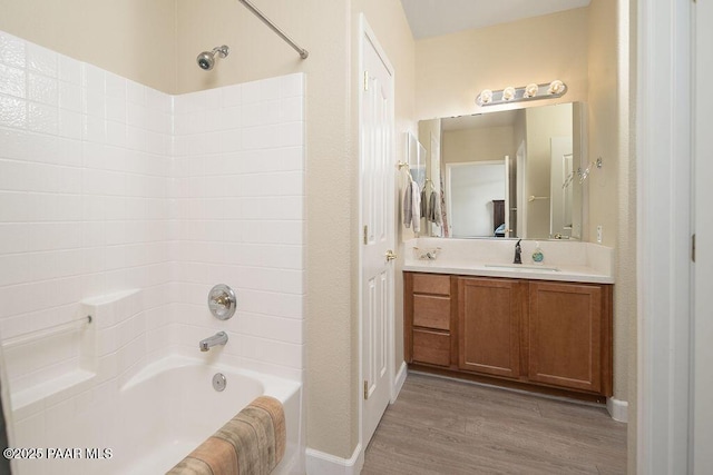 bathroom with vanity, hardwood / wood-style flooring, and bathing tub / shower combination