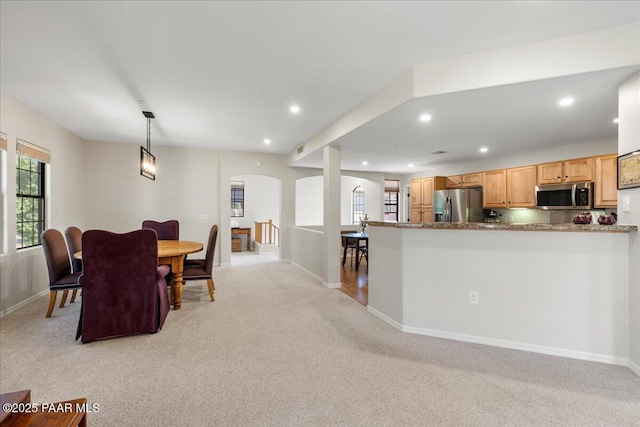 1716 Alpine Meadows Ln Unit 602, Prescott, AZ 86303 - kitchen with stainless steel appliances, light carpet, arched walkways, recessed lighting, and light brown cabinets