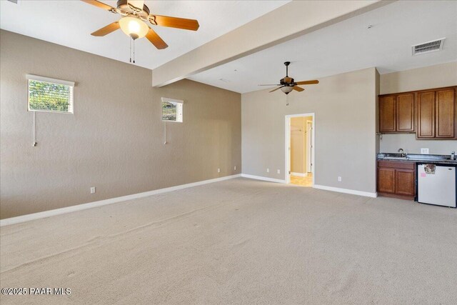 1183 Northridge Dr, Prescott, AZ 86301 - unfurnished living room with ceiling fan, light carpet, and beamed ceiling