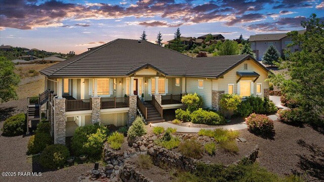 1183 Northridge Dr, Prescott, AZ 86301 - view of front facade featuring stairs, a porch, stone siding, and a tiled roof