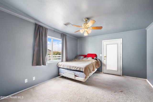 bedroom with carpet floors, crown molding, a textured ceiling, and ceiling fan