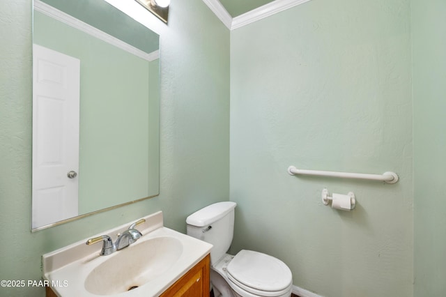 bathroom featuring vanity, crown molding, and toilet