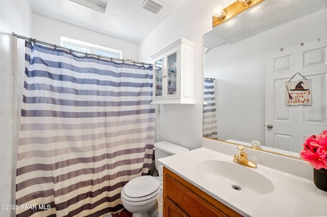 bathroom with vanity, toilet, and walk in shower