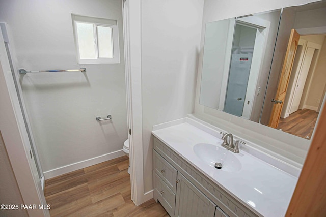 1251 Navajo Way, Prescott, AZ 86305 - bathroom with vanity, toilet, wood finished floors, and baseboards