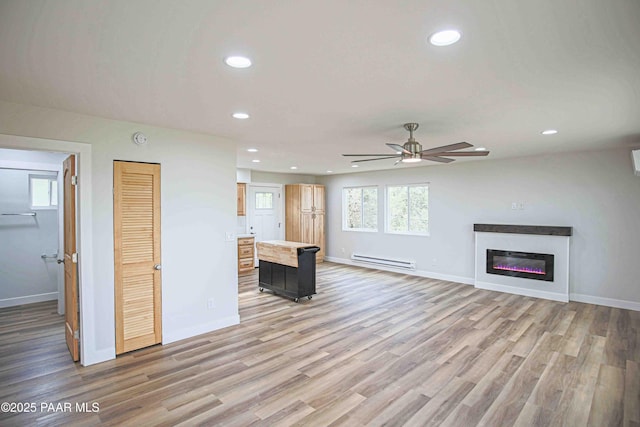 1251 Navajo Way, Prescott, AZ 86305 - unfurnished living room featuring a baseboard heating unit, ceiling fan, recessed lighting, light wood finished floors, and baseboards
