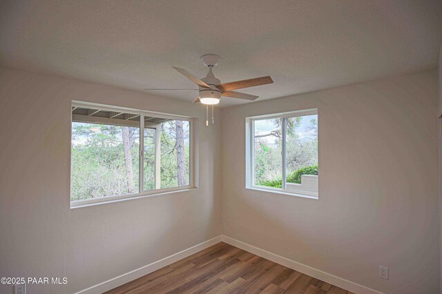 1251 Navajo Way, Prescott, AZ 86305 - unfurnished room with baseboards, wood finished floors, and a ceiling fan