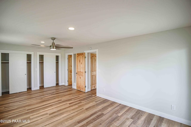 1251 Navajo Way, Prescott, AZ 86305 - unfurnished bedroom with baseboards, two closets, recessed lighting, light wood-style flooring, and a ceiling fan