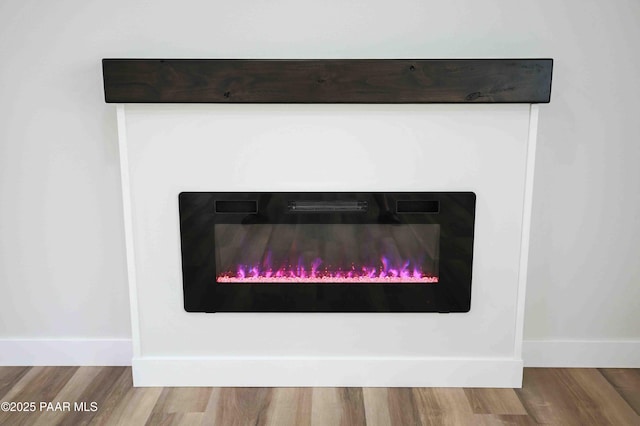 1251 Navajo Way, Prescott, AZ 86305 - detailed view of a glass covered fireplace, baseboards, and wood finished floors