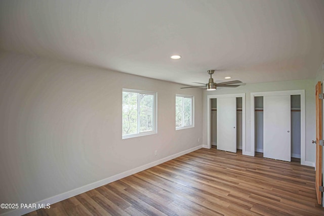 1251 Navajo Way, Prescott, AZ 86305 - unfurnished bedroom featuring baseboards, two closets, recessed lighting, wood finished floors, and a ceiling fan