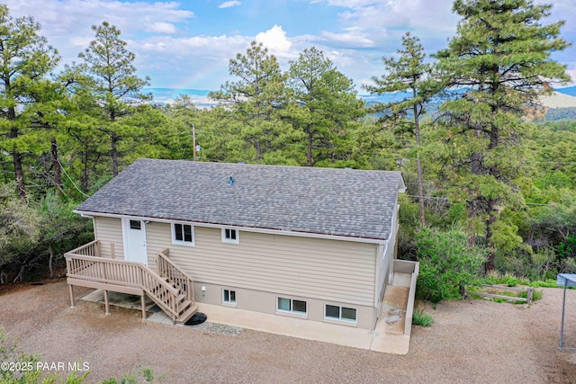 1251 Navajo Way, Prescott, AZ 86305 - rear view of property with a shingled roof, a wooden deck, a forest view, and stairway